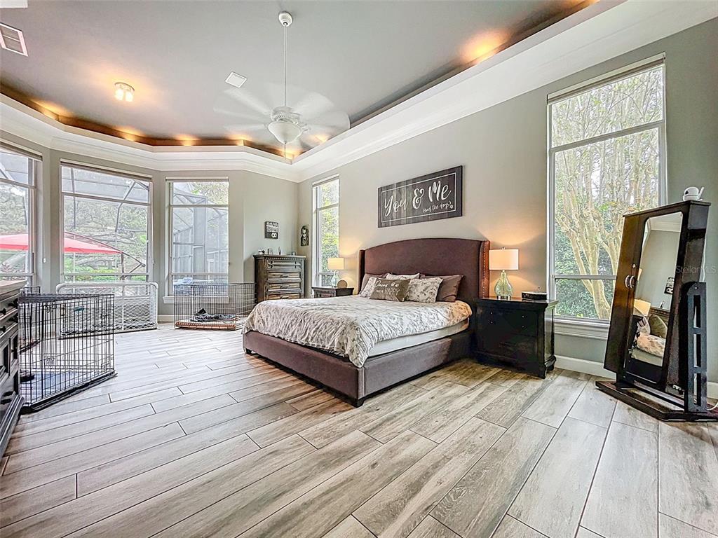 414 Westgate Road Tarpon Springs, FL 34688 - Photo 17 of 75 a bedroom with a large bed a flat tv screen and dresser