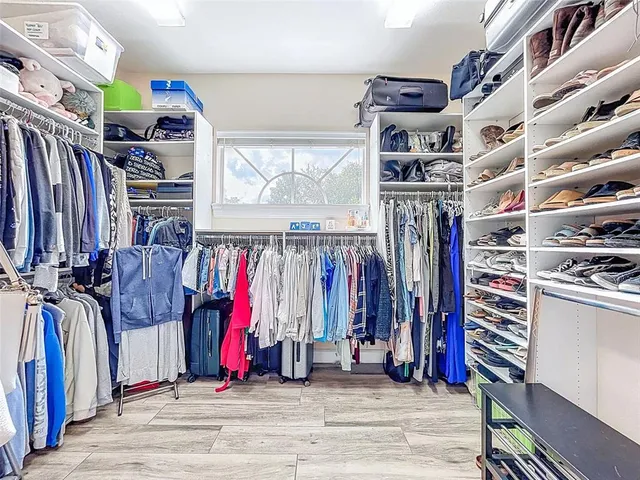 a bedroom with a bed wooden floor and window