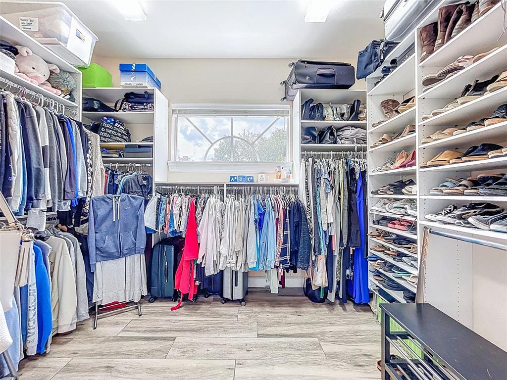 414 Westgate Road Tarpon Springs, FL 34688 - Photo 21 of 75 a view of walk in closet with clothes and shoes