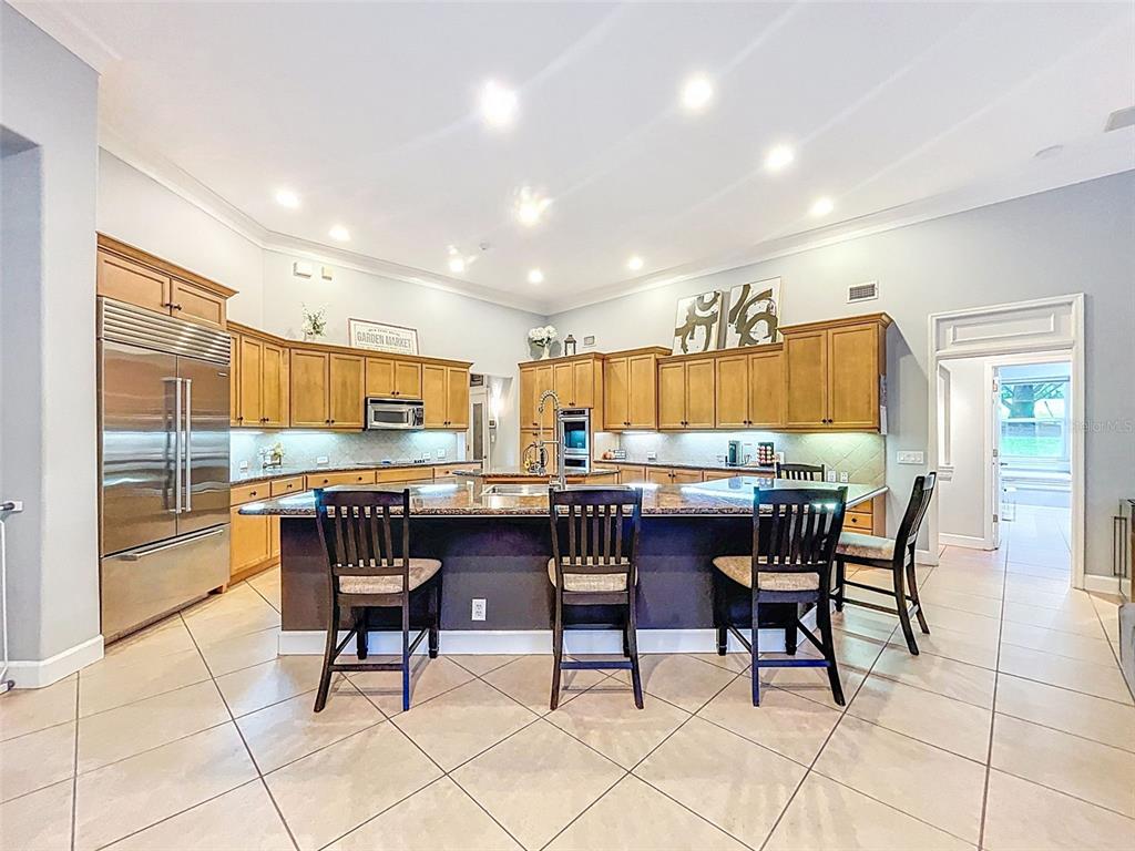 414 Westgate Road Tarpon Springs, FL 34688 - Photo 23 of 75 a kitchen with a dining table chairs and large window