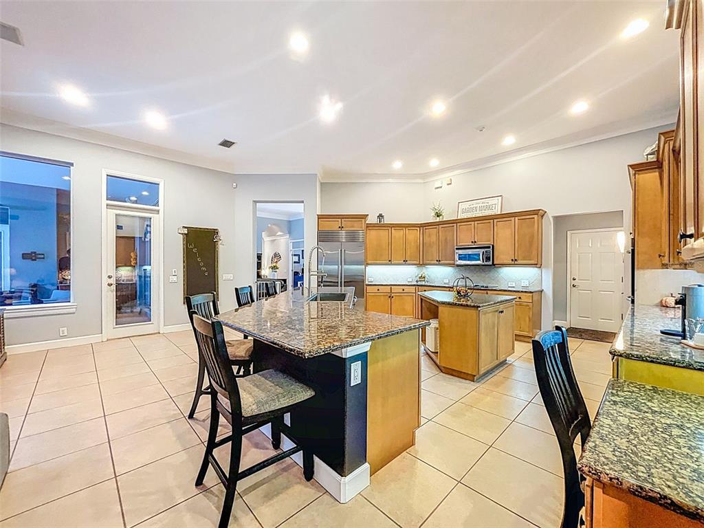 414 Westgate Road Tarpon Springs, FL 34688 - Photo 24 of 75 a kitchen with a dining table chairs and view of living room