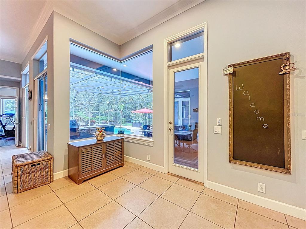 414 Westgate Road Tarpon Springs, FL 34688 - Photo 25 of 75 a room with open cabinet and mirrors