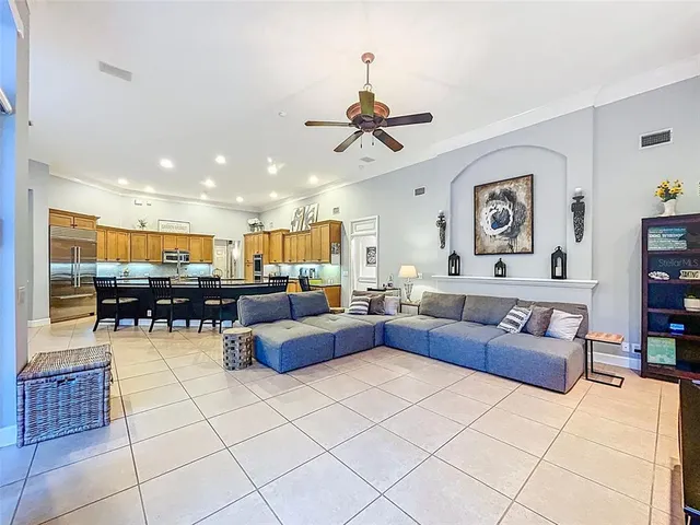 a spacious bedroom with a bed a large window and walk in closet