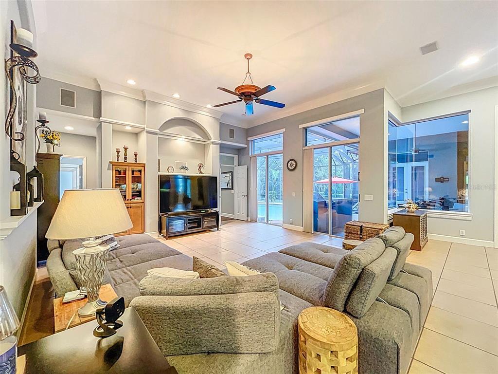 414 Westgate Road Tarpon Springs, FL 34688 - Photo 30 of 75 a living room with furniture and a chandelier