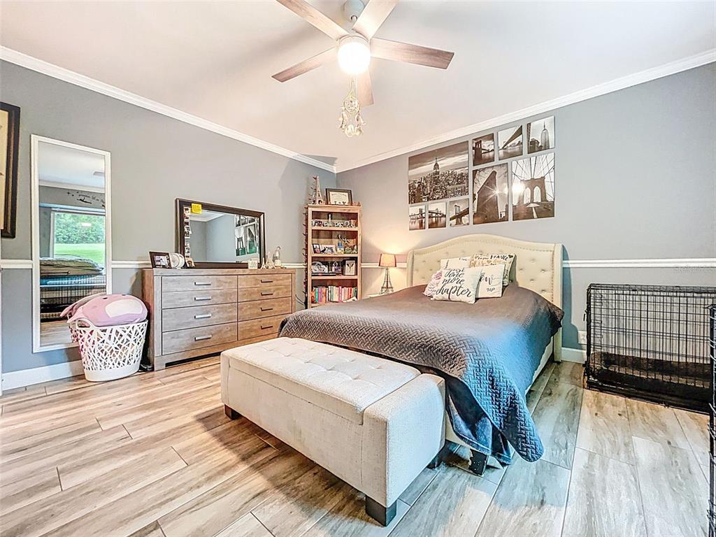 414 Westgate Road Tarpon Springs, FL 34688 - Photo 32 of 75 a bedroom with a bed wooden floor and window