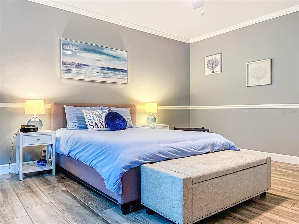 414 Westgate Road Tarpon Springs, FL 34688 - Photo 36 of 75 a bedroom with bed and painting on the wall