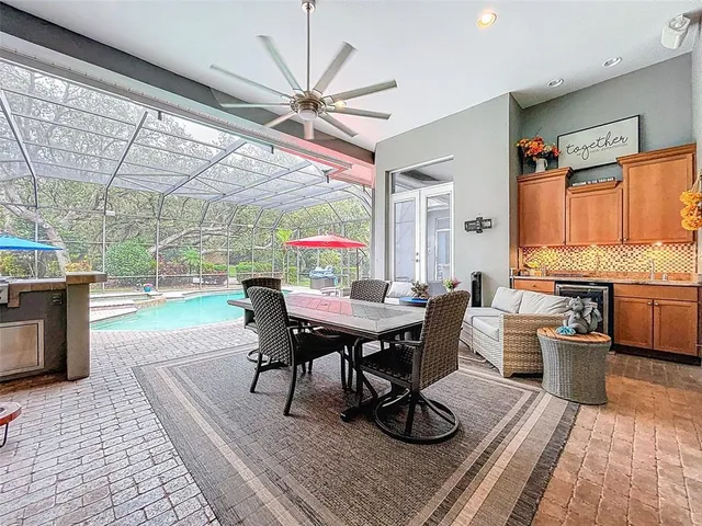 a view of swimming pool with outdoor seating and a patio
