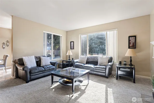 a living room with furniture a rug and a large window