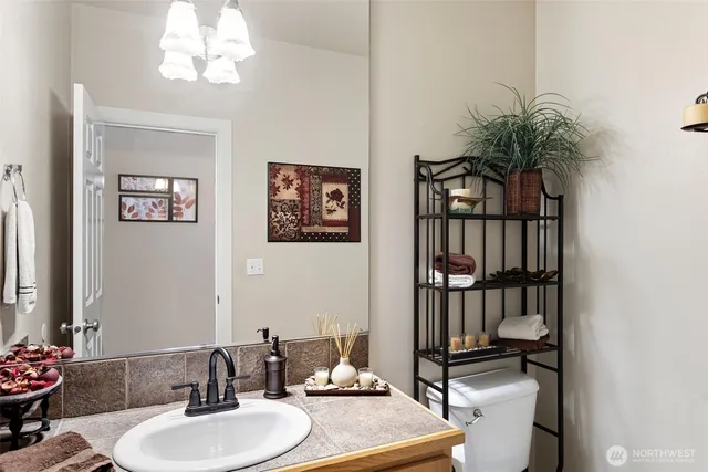 a bathroom with a sink toilet and a mirror