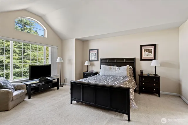 a bedroom with a bed and a tv