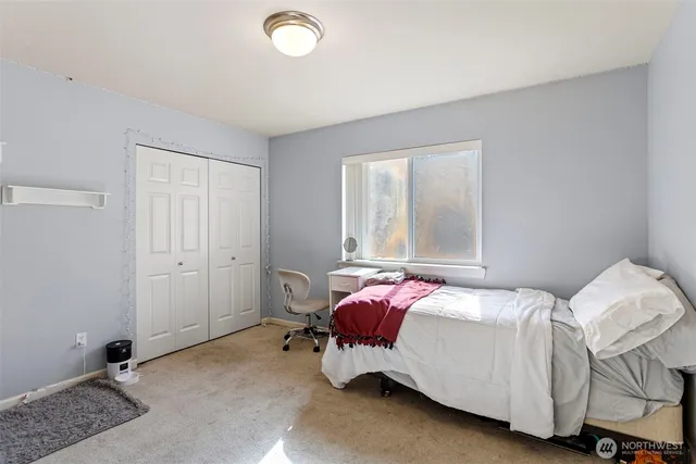 a bedroom with a bed and window