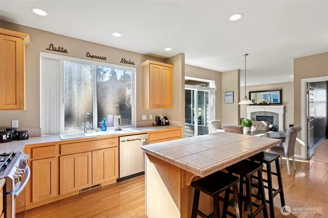 a kitchen with a stove a sink a dining table and chairs