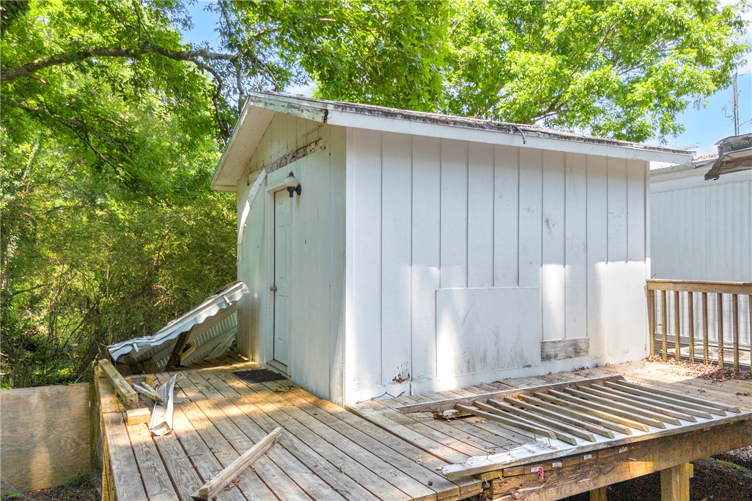 150 Newberry Road Walhalla, SC 29691 - Photo 28 of 47 A secluded outbuilding offers additional storage amidst a backdrop of lush foliage.