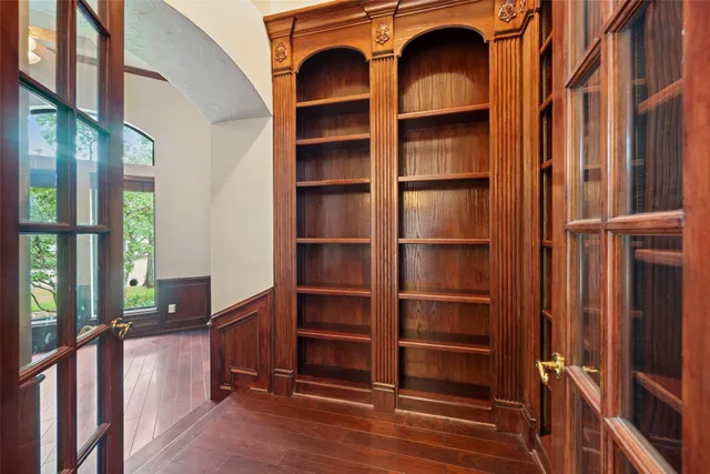 a view of a livingroom with wooden floor and a large window