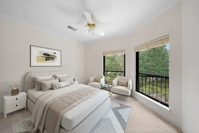 a bedroom with a balcony a bed and a large window