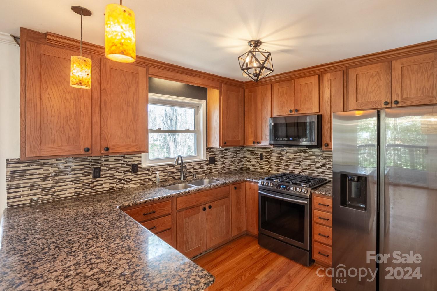 1177 Molokai Drive Tega Cay, SC 29708 - Photo 14 of 41 a kitchen with stainless steel appliances granite countertop a sink stove and refrigerator