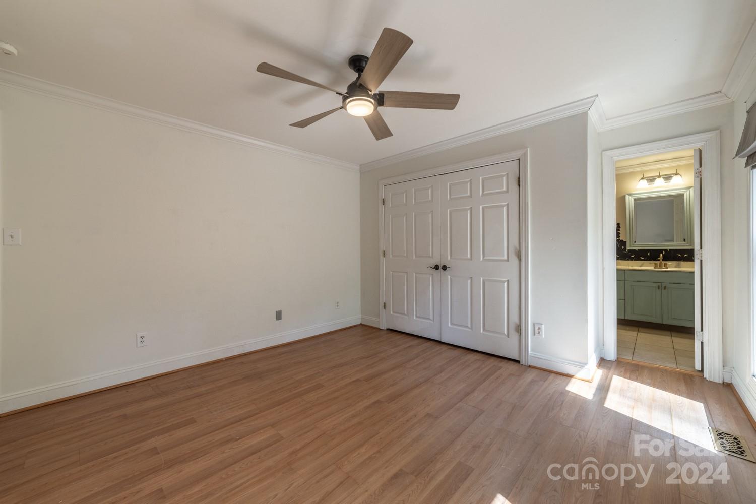 1177 Molokai Drive Tega Cay, SC 29708 - Photo 22 of 41 an empty room with wooden floor fan and windows