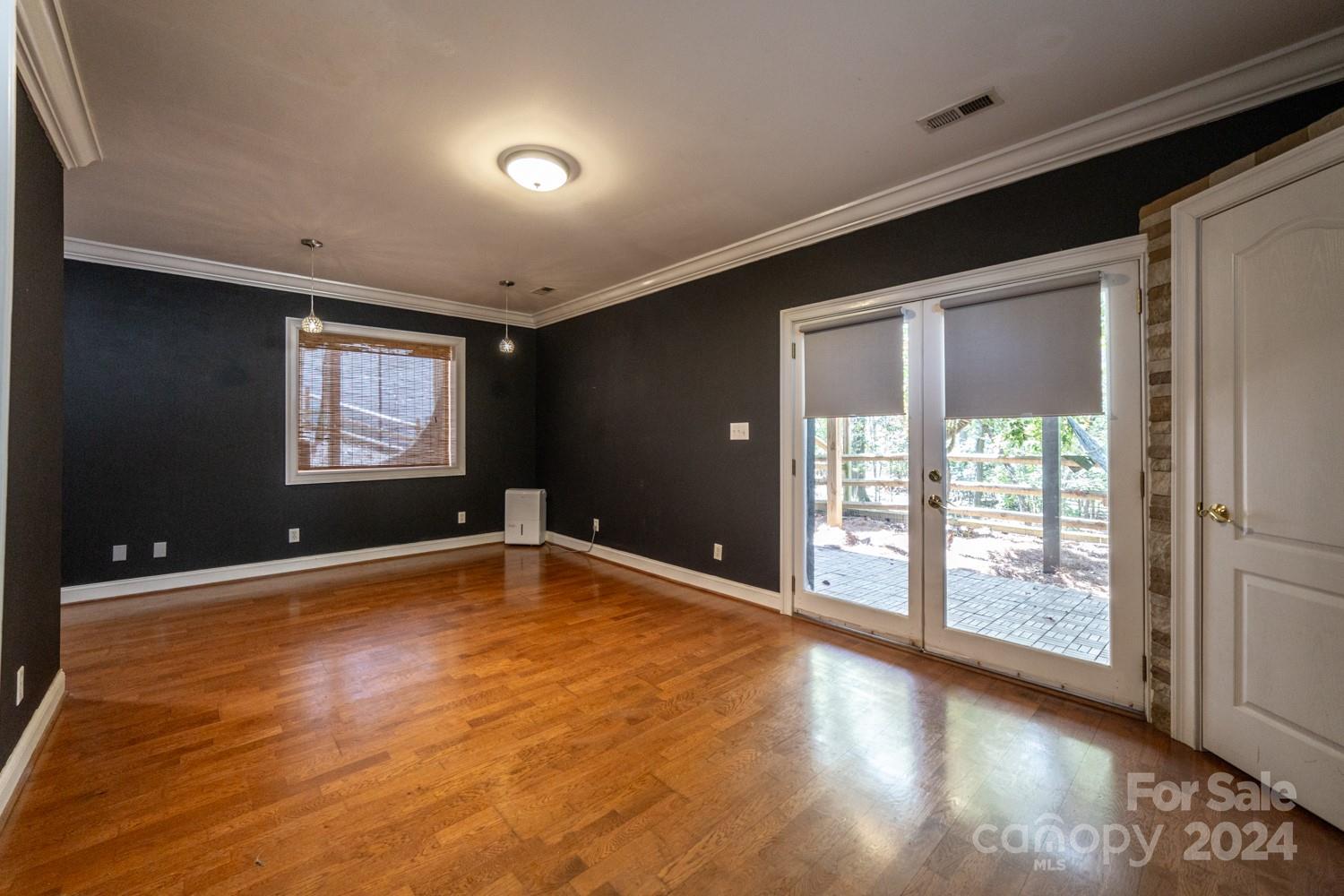 1177 Molokai Drive Tega Cay, SC 29708 - Photo 24 of 41 a view of an empty room with a window and wooden floor