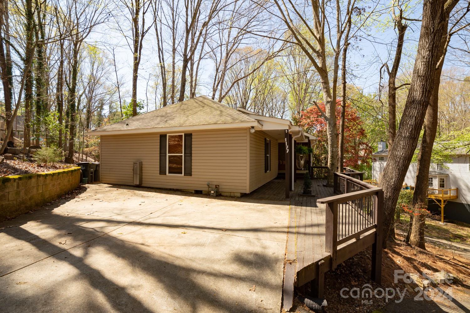 1177 Molokai Drive Tega Cay, SC 29708 - Photo 4 of 41 a backyard of a house with large trees and outdoor seating