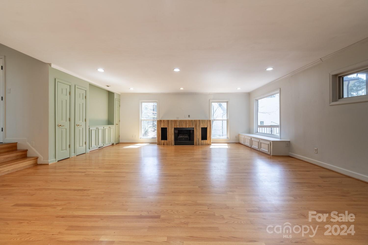 1177 Molokai Drive Tega Cay, SC 29708 - Photo 8 of 41 a view of empty room with a fireplace and wooden floor