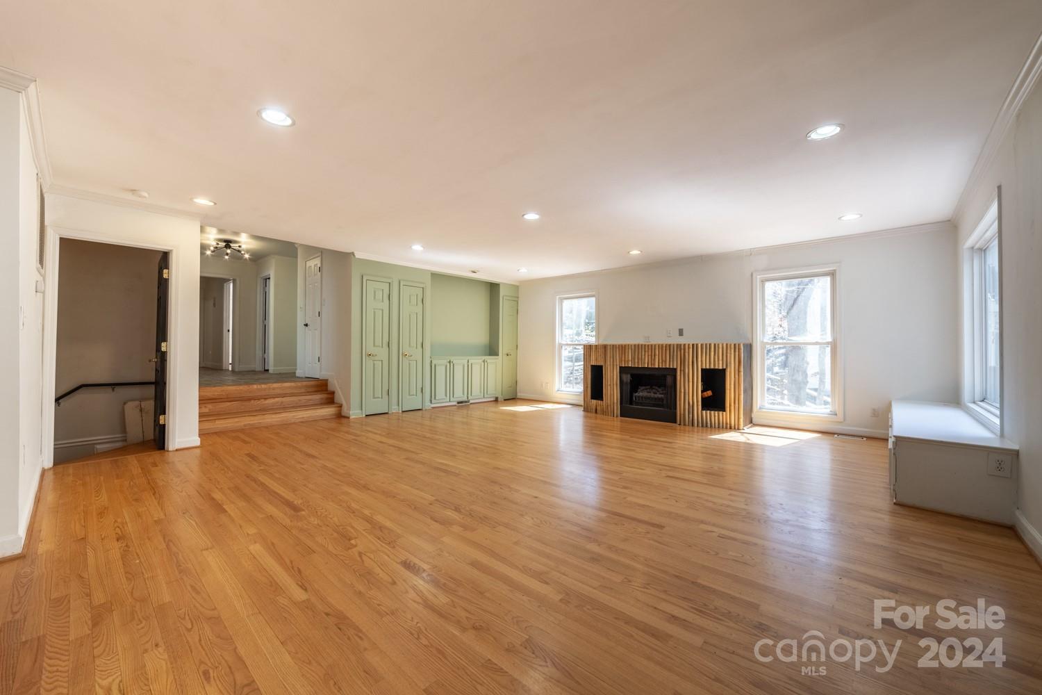 1177 Molokai Drive Tega Cay, SC 29708 - Photo 9 of 41 a view of empty room with wooden floor and fireplace