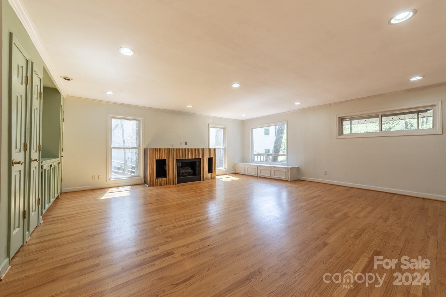 1177 Molokai Drive Tega Cay, SC 29708 - Photo 10 of 41 an empty room with wooden floor and fireplace