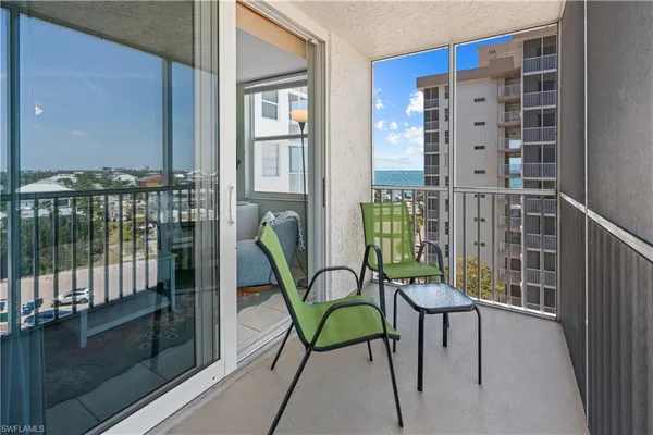 a view of a balcony with chairs