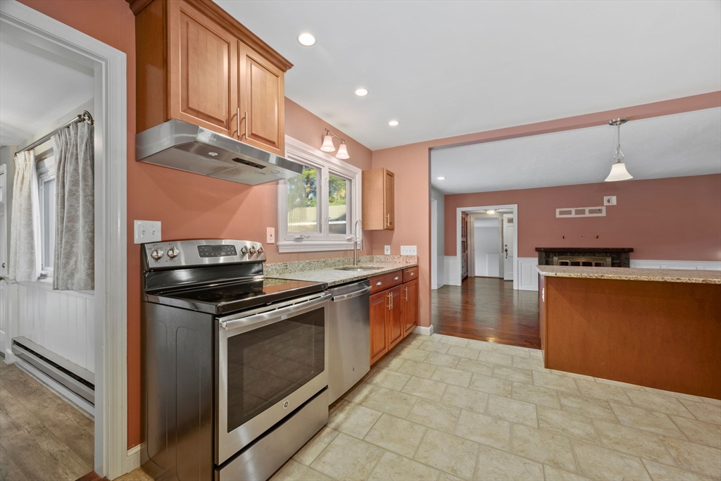 216 Boston Road Southborough, MA 01772 - Photo 7 of 30 a kitchen with stainless steel appliances granite countertop a stove and a sink