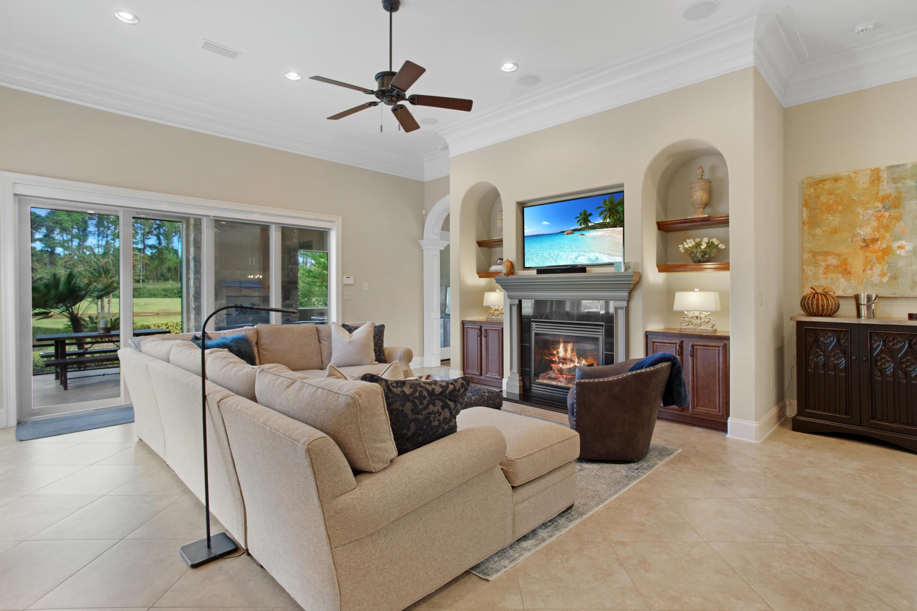 2946 Pine Valley Road Miramar Beach, FL 32550 - Photo 10 of 52 a living room with furniture a fireplace a flat screen tv and a large window