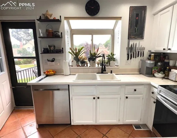 a kitchen with a sink and large cabinets