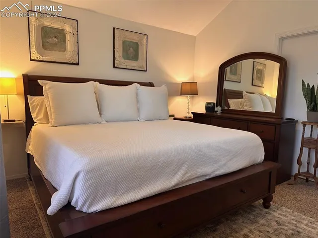 a bedroom with a bed and lamp