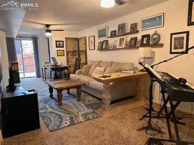 a living room with furniture a rug and a wall painting