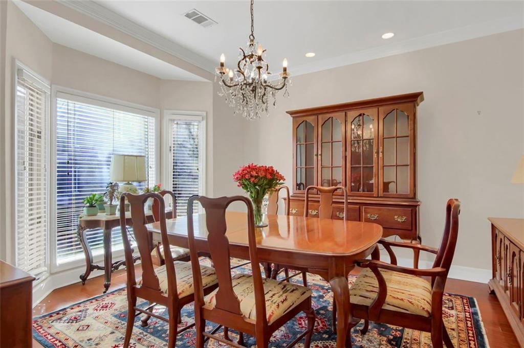 5364 Brooke Ridge Drive Dunwoody, GA 30338 - Photo 14 of 34 a dining room with furniture a chandelier and wooden floor