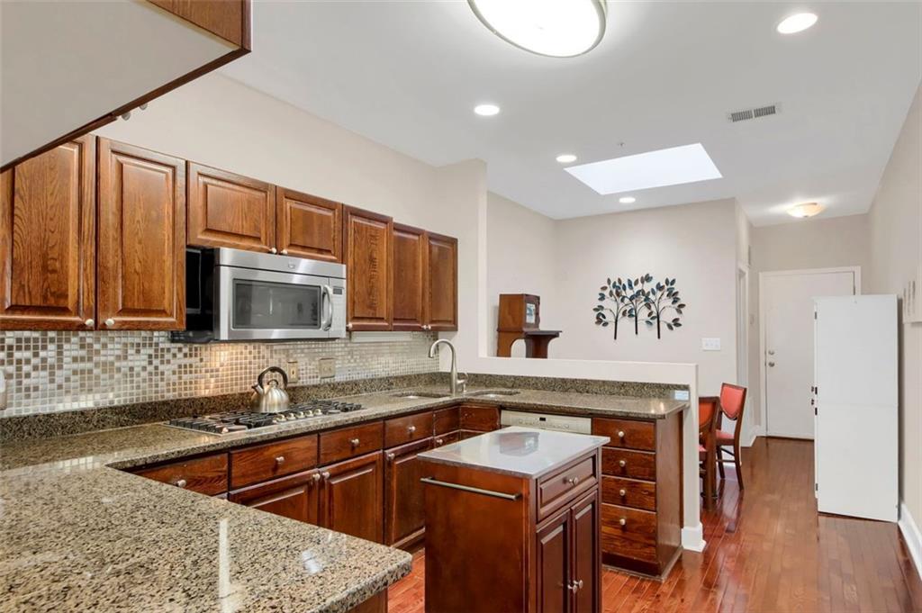 5364 Brooke Ridge Drive Dunwoody, GA 30338 - Photo 15 of 34 a kitchen with stainless steel appliances granite countertop a sink stove and microwave