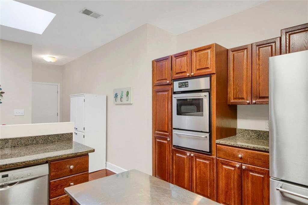 5364 Brooke Ridge Drive Dunwoody, GA 30338 - Photo 18 of 34 a kitchen with stainless steel appliances granite countertop a refrigerator a stove and a sink