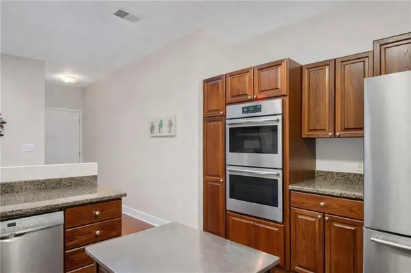 a kitchen with stainless steel appliances granite countertop a sink stove and microwave
