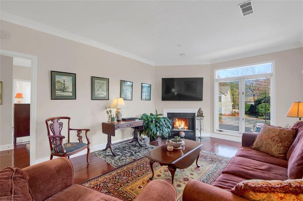 5364 Brooke Ridge Drive Dunwoody, GA 30338 - Photo 10 of 34 a living room with furniture a fireplace and a flat screen tv