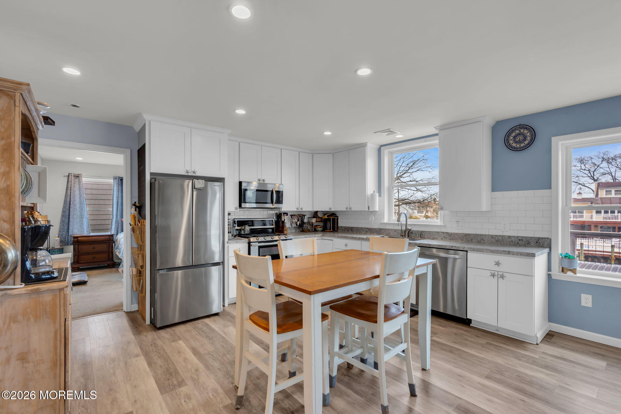 1622 Center Street Point Pleasant, NJ 08742 - Photo 19 of 42 a kitchen with white cabinets and stainless steel appliances