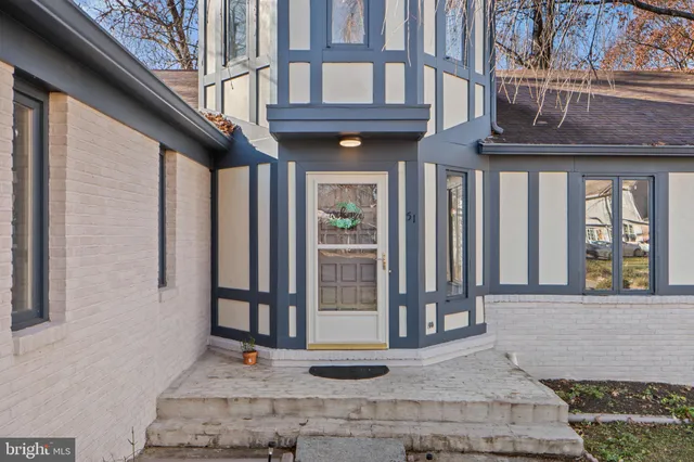a front view of a building with glass windows and door