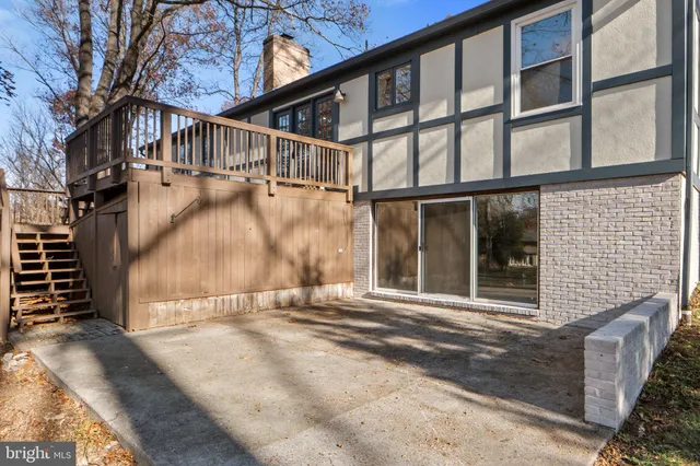 a view of a patio with table and chairs