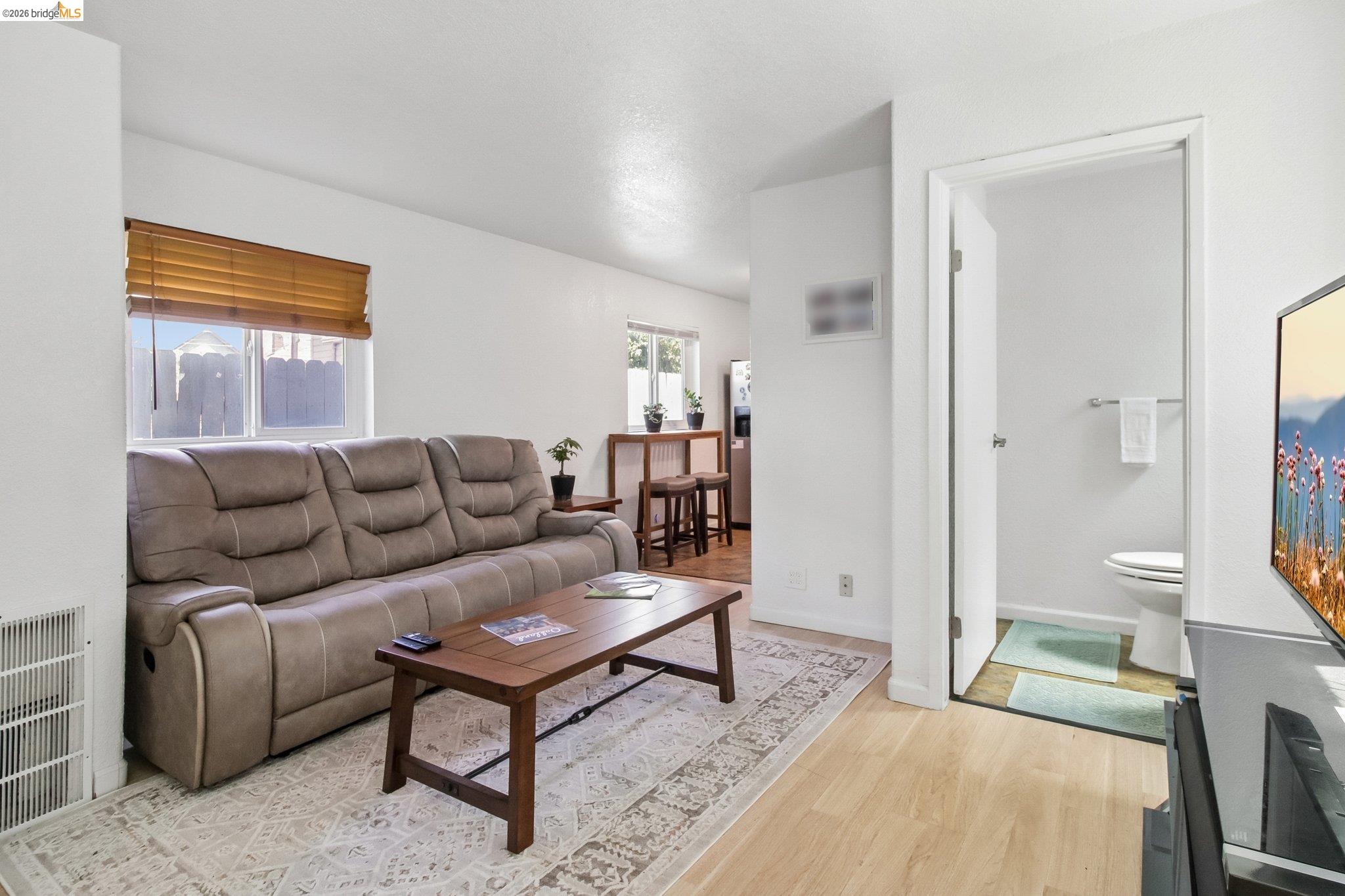 874 Pine Street Oakland, CA 94607 - Photo 5 of 39 Light wood-finish flooring complements a neutral wall palette
