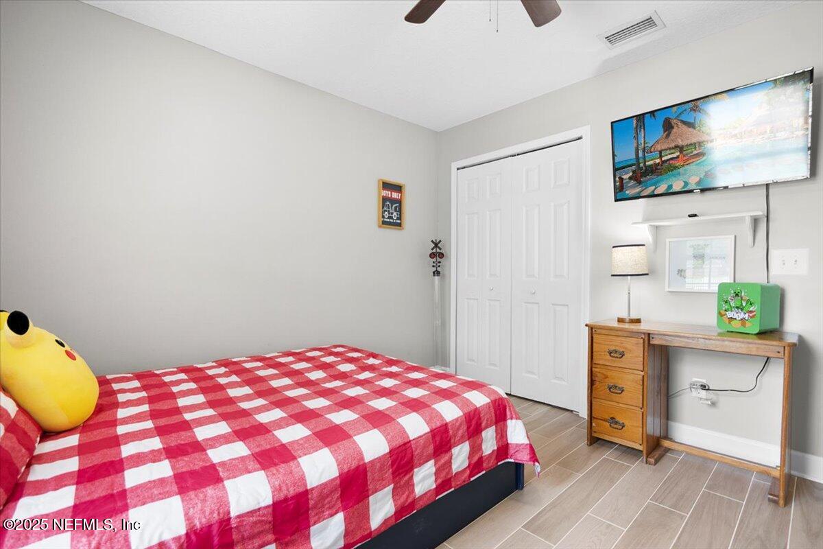 53347 Clear Lake Drive Callahan, FL 32011 - Photo 15 of 41 a bedroom with a bed and a flat screen tv
