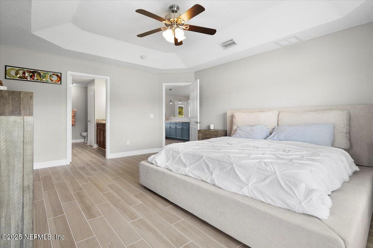 53347 Clear Lake Drive Callahan, FL 32011 - Photo 16 of 41 a bedroom with a bed and a ceiling fan