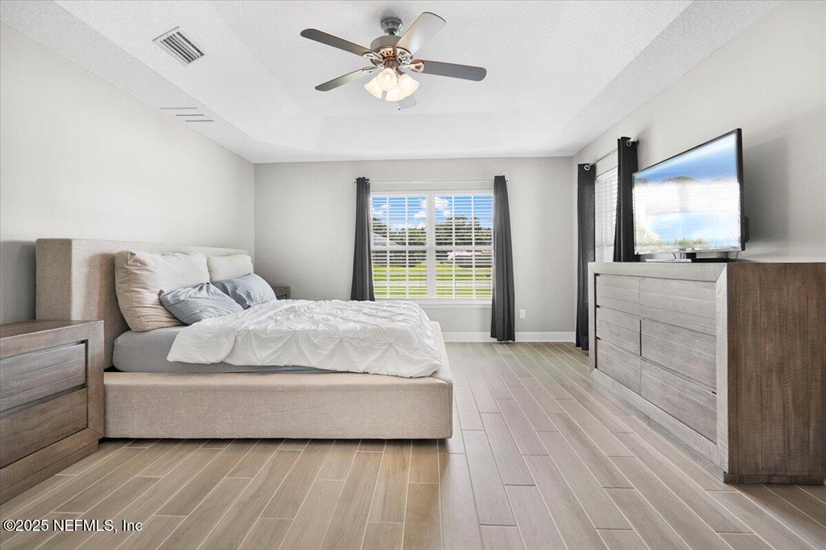 53347 Clear Lake Drive Callahan, FL 32011 - Photo 18 of 41 a spacious bedroom with a bed and a large window