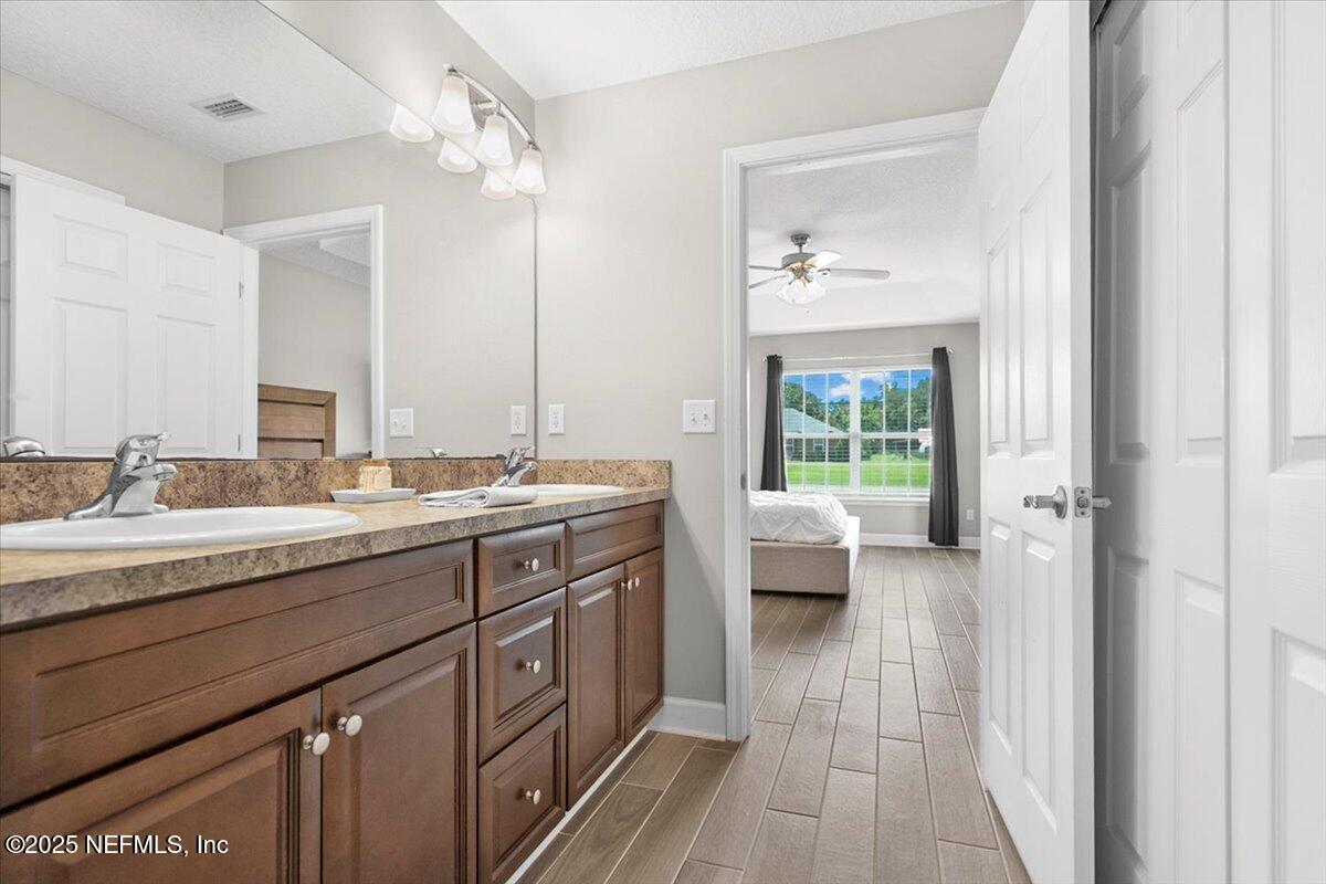 53347 Clear Lake Drive Callahan, FL 32011 - Photo 19 of 41 a spacious bathroom with a granite countertop sink and a mirror