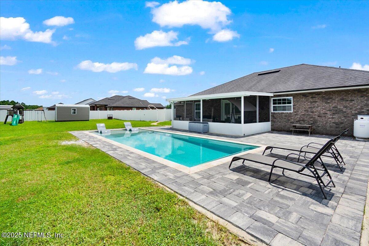 53347 Clear Lake Drive Callahan, FL 32011 - Photo 25 of 41 a view of a house with swimming pool and porch