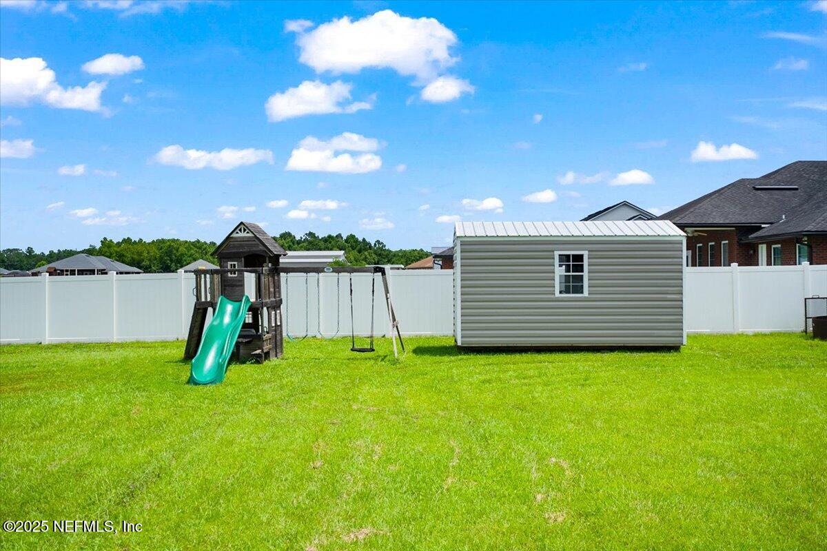53347 Clear Lake Drive Callahan, FL 32011 - Photo 29 of 41 a view of a backyard with a garden and entertaining space