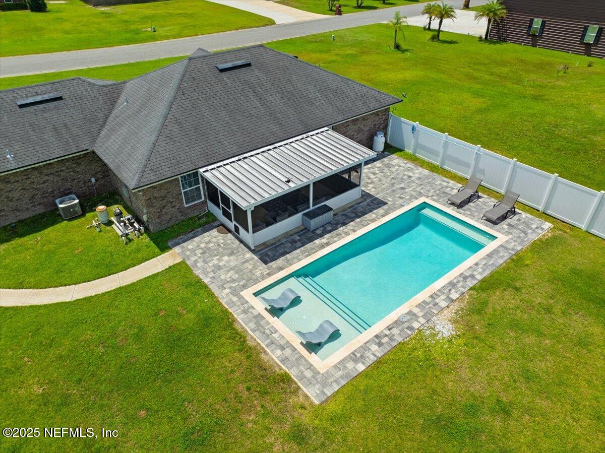 53347 Clear Lake Drive Callahan, FL 32011 - Photo 31 of 41 a view of a backyard with lawn chairs and a small yard