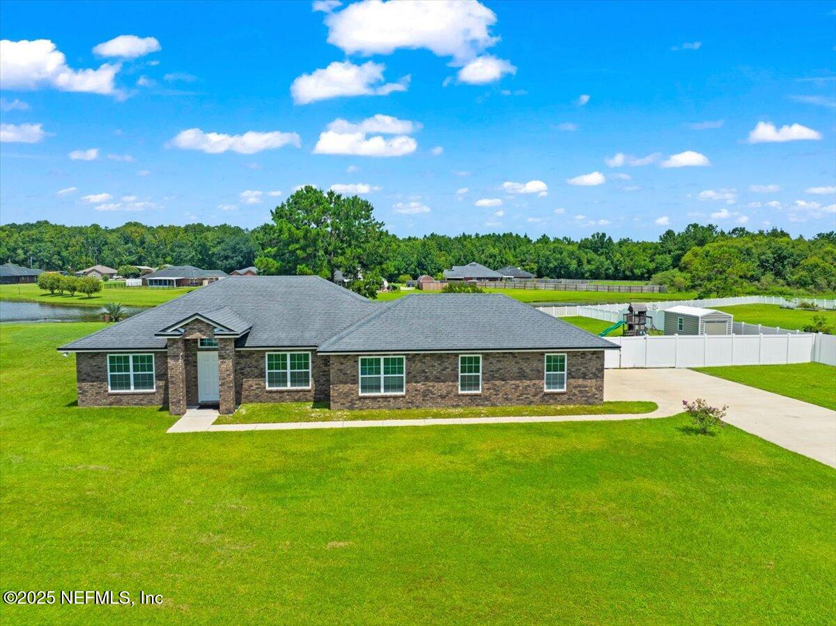 53347 Clear Lake Drive Callahan, FL 32011 - Photo 32 of 41 a house with swimming pool in front of it