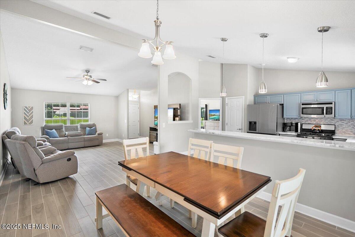 53347 Clear Lake Drive Callahan, FL 32011 - Photo 7 of 41 a living room with furniture a chandelier and a dining table